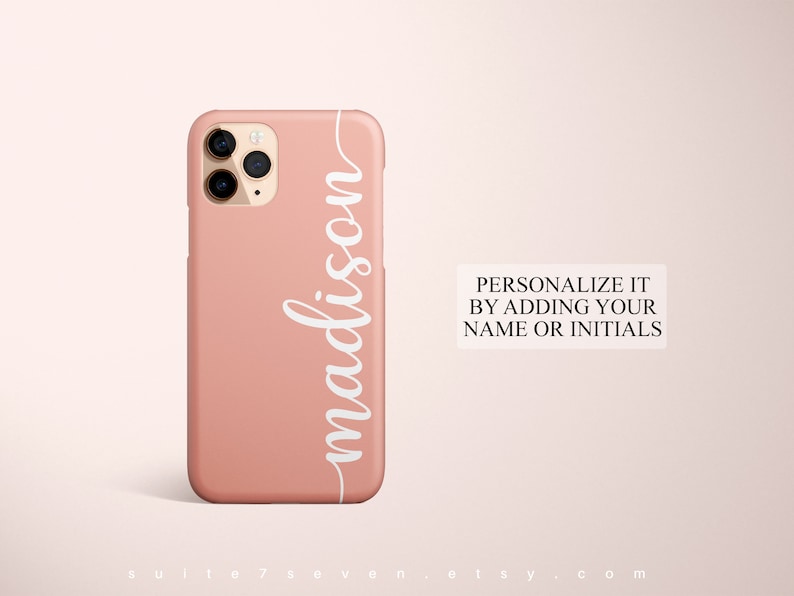May include: A pink phone case with a white cursive name "madison" on the side. The text "PERSONALIZE IT BY ADDING YOUR NAME OR INITIALS" is visible below the phone case.