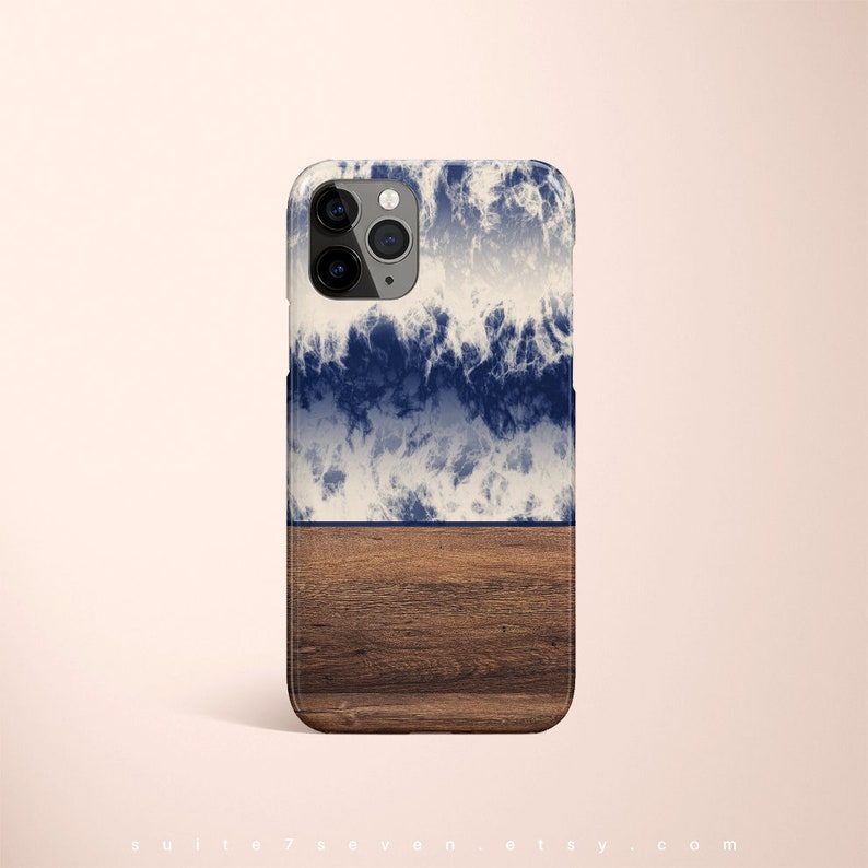May include: A phone case with a blue and white wave design and a brown wood grain pattern on the bottom half.