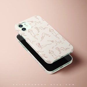 May include: A white iPhone case with a pattern of red line drawings of people in yoga poses. The case is shown with the phone inside, and the phone is black.