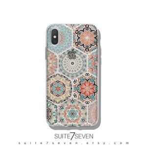 May include: A clear phone case with a colorful mandala pattern. The case is designed for an iPhone X. The pattern features a variety of colors, including blue, green, orange, and red.