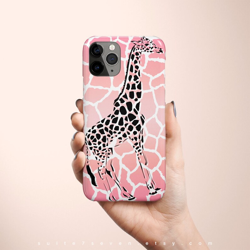 May include: A pink and white iPhone case with a black and white giraffe silhouette. The giraffe is standing on a pink and white giraffe print background.