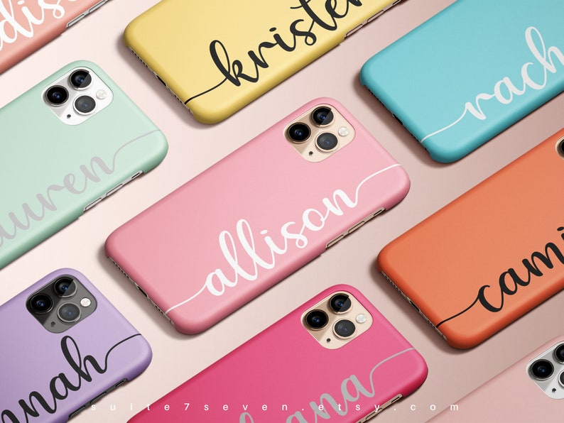 May include: A collection of personalized phone cases with various names written in a cursive font. The cases are in different colors, including pink, green, blue, yellow, and orange. Each case features a white or black cursive name.