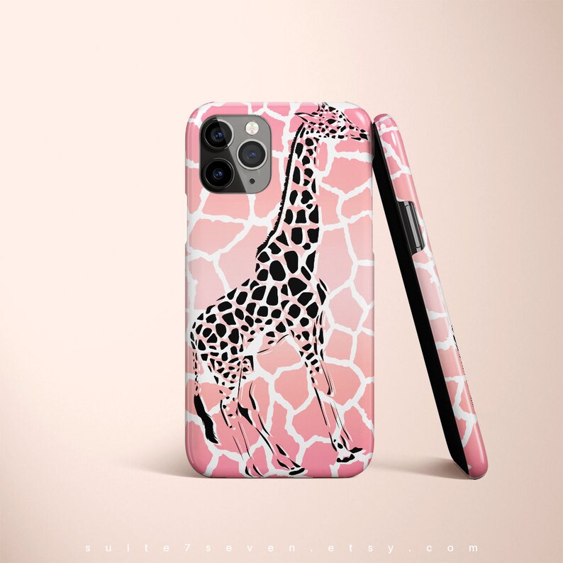 May include: A pink and white phone case with a black giraffe silhouette. The giraffe is standing on a pink and white giraffe print background.