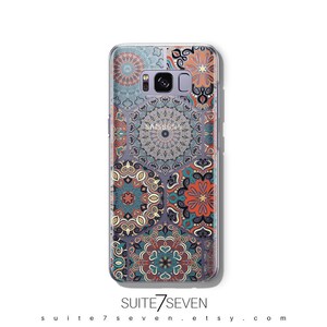 May include: A clear phone case with a colorful mandala pattern. The case is designed for a Samsung Galaxy phone. The pattern features a variety of colors, including blue, green, red, orange, and yellow.