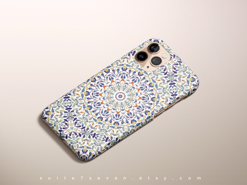 May include: A white iPhone case with a colorful mandala pattern. The case has a blue, green, yellow, and orange design. The case is designed for an iPhone with a triple camera lens.