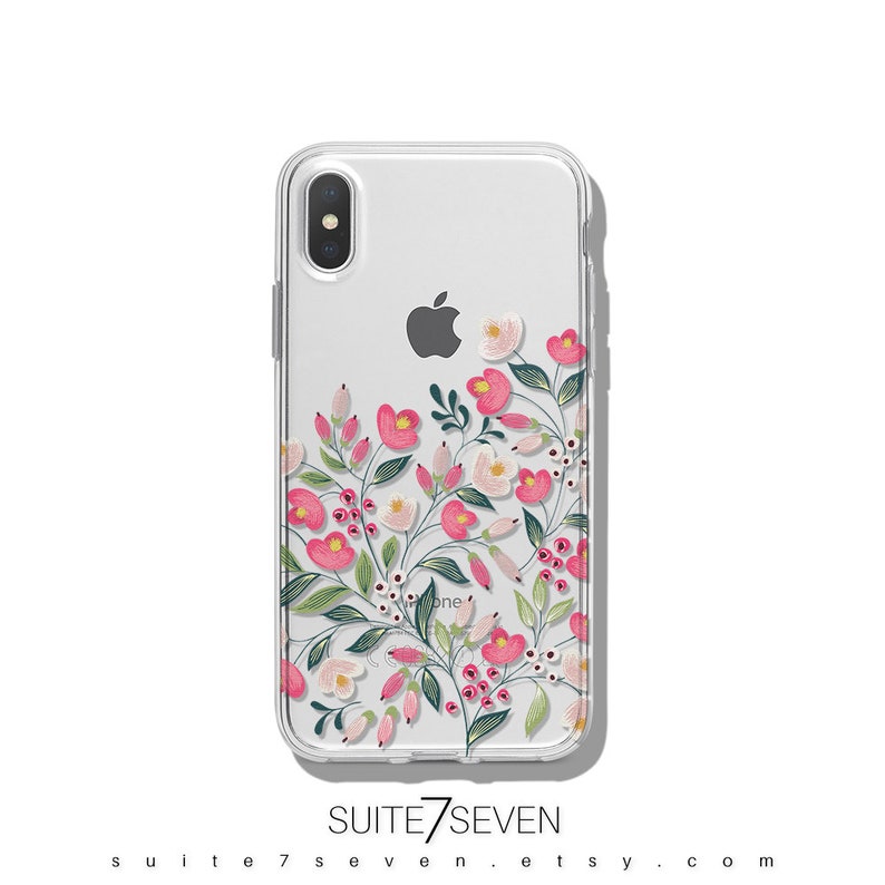 Puede incluir: Una funda transparente para tel&eacute;fono con un dise&ntilde;o floral que presenta flores rosas y blancas, hojas verdes y bayas rojas. La funda es compatible con iPhone X.