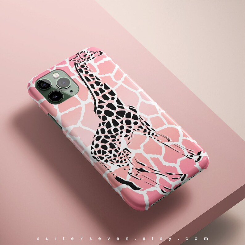May include: A pink iPhone case with a black and white giraffe illustration on a pink and white giraffe print background.