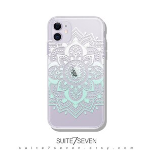 May include: A clear phone case with a white mandala design. The mandala is a circular pattern with intricate details. The case is designed for an iPhone 12 Pro Max.
