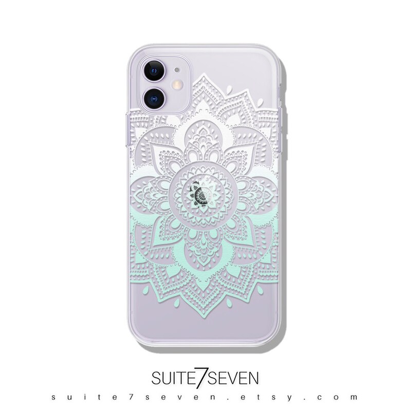May include: A clear phone case with a white mandala design. The mandala is a circular pattern with intricate details. The case is designed for an iPhone 12 Pro Max.