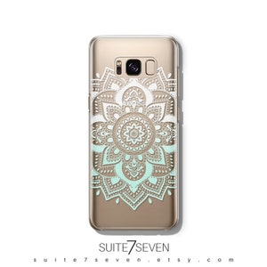 May include: A clear phone case with a white and light blue mandala design. The case is designed for a Samsung Galaxy S8 phone.