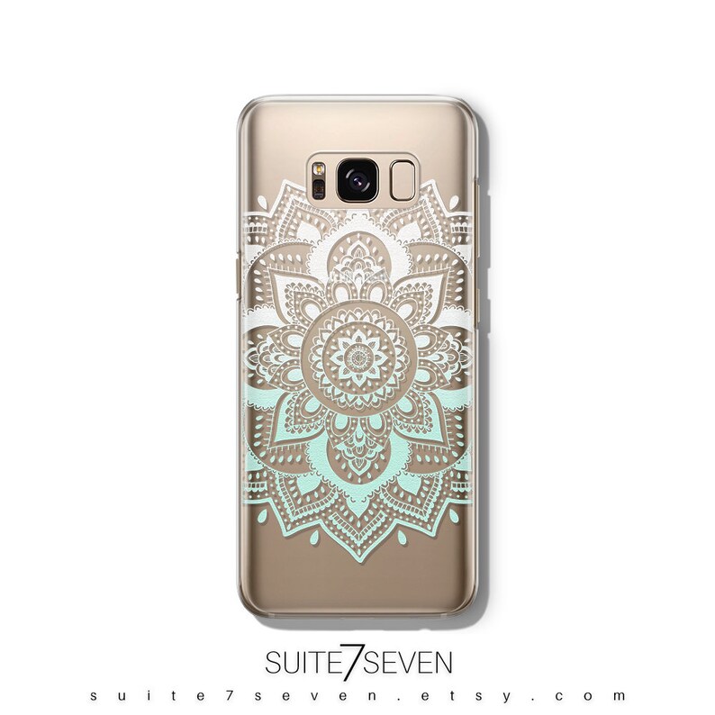 May include: A clear phone case with a white and light blue mandala design. The case is designed for a Samsung Galaxy S8 phone.