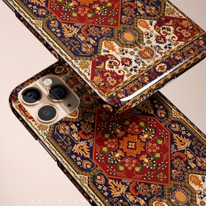 May include: A phone case with a colorful, intricate patterned design reminiscent of a Persian rug. The case features a blue, red, and gold color scheme with floral and geometric motifs.