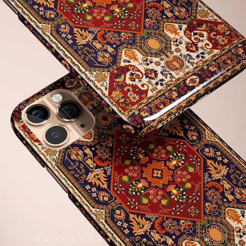 May include: A phone case with a colorful, intricate patterned design reminiscent of a Persian rug. The case features a blue, red, and gold color scheme with floral and geometric motifs.