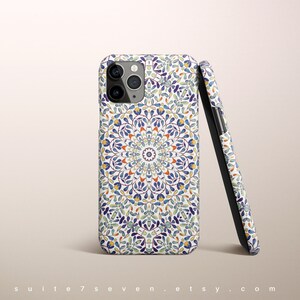May include: A white phone case with a blue, green, and orange mandala pattern. The case is designed for an iPhone.