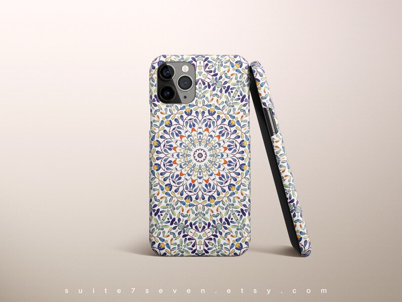 May include: A white phone case with a blue, green, and orange mandala pattern. The case is designed for an iPhone.