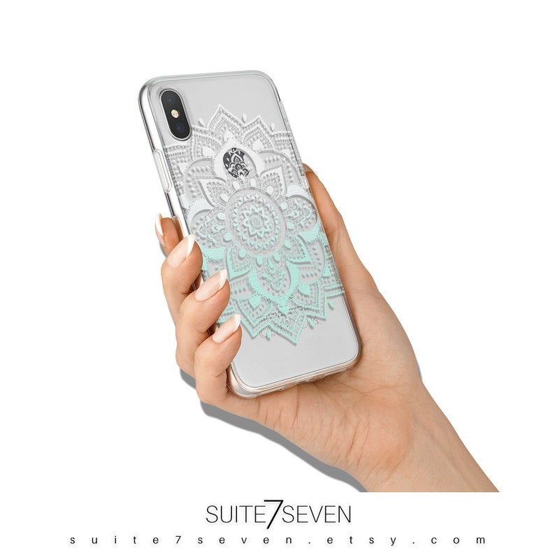 May include: A clear phone case with a white and light blue mandala design. The case is made of a flexible, durable material and is compatible with the iPhone X.