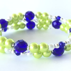 May include: A double-strand bracelet with green, white, and blue beads. The bracelet is made with small round green beads, small white beads, and larger faceted blue beads.
