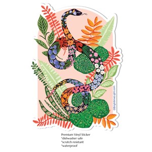 May include: A vibrant sticker with a floral snake illustration. The snake is decorated with blue, pink, orange, and yellow flowers, set against green leaves. The sticker is dishwasher safe, scratch resistant, and waterproof.