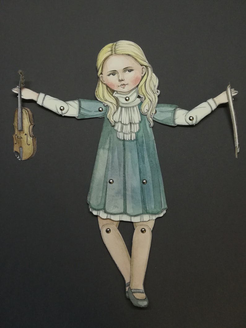 May include: A paper doll illustration of a girl in a teal dress, holding a violin and bow. The doll has blonde hair and is jointed at the arms and legs. The background is a solid black.