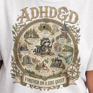 May include: A white t-shirt featuring a circular fantasy map graphic with the text ADHD&D at the top and FOREVER ON A SIDE QUEST at the bottom. The map depicts a central raccoon character surrounded by locations labeled Distraction Hollow, Shiny Objects, Random Research Tower, Procrastination Peak, Maybe Later Vault, Snack Enclave, Daydream Depths, and Hyperfocus Lab.
