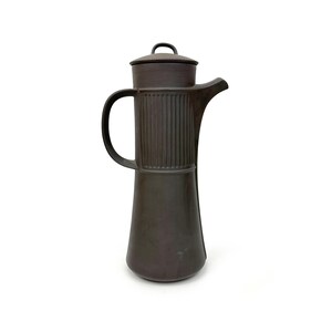 May include: A dark brown ceramic coffee pot with a lid and a handle. The pot has a textured, ribbed design.