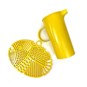May include: A yellow plastic pitcher and a yellow plastic fish-shaped trivet.