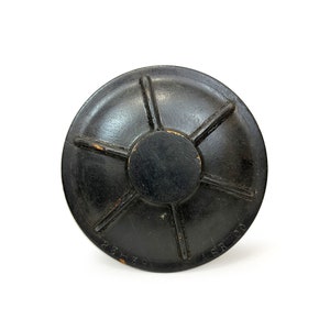 May include: Black round wooden lid with a starburst design and the text "A.S.R. CO. 25-30" on the bottom.