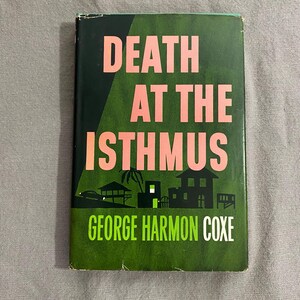 May include: A green book cover with the title "Death at the Isthmus" in pink lettering. The author's name, "George Harmon Coxe", is printed in white below the title.