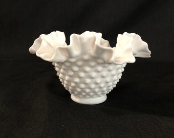May include: White milk glass bowl with a ruffled edge and a textured, dotted surface.