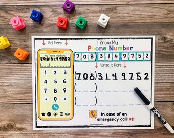 May include: A printable worksheet for kids to learn their phone number. The worksheet features a colorful phone with a dial pad and a space to write the phone number. The phone number is displayed in a row of colorful blocks. The worksheet also includes an emergency contact number.