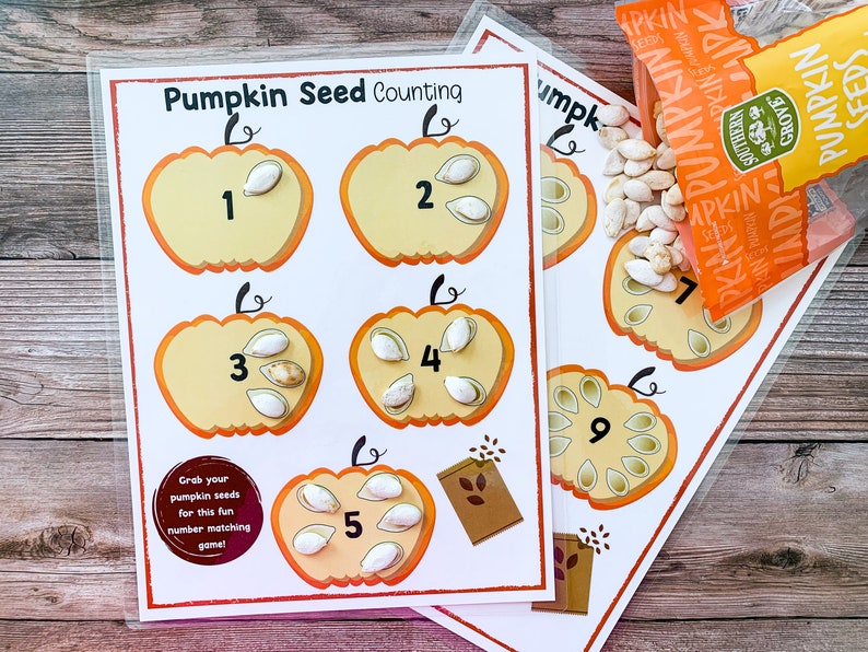 May include: A printable pumpkin seed counting activity for kids. The printable features five pumpkins with numbers 1 through 5 and a corresponding number of pumpkin seeds inside each pumpkin. The text "Grab your pumpkin seeds for this fun number matching game!" is at the bottom of the page.