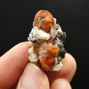 An aesthetic Specimen of spessartine garnet on matrix with uv reactive apatite crystal from Pakistan, 13.6 grams