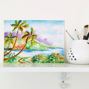 May include: Watercolor painting of a tropical scene with palm trees, a lake, and mountains in the background. The painting is done in shades of green, blue, purple, and pink.