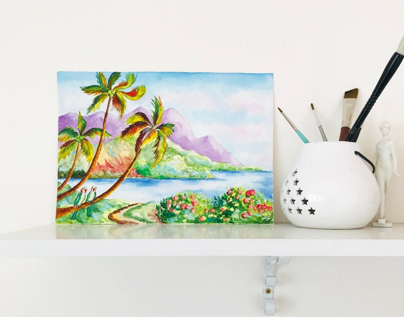 May include: Watercolor painting of a tropical scene with palm trees, a lake, and mountains in the background. The painting is done in shades of green, blue, purple, and pink.