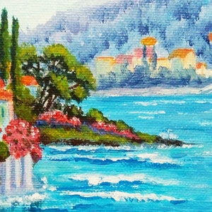 May include: A painting depicting a seascape with a small town in the background. The town is situated on a hill and features white buildings with orange roofs. The foreground showcases a small island with green trees and pink flowers. The water is a vibrant blue with white waves.