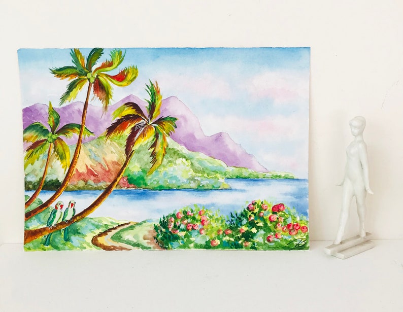 May include: Watercolor painting of a tropical landscape with palm trees, a body of water, and mountains in the background. Two green parrots are perched on a palm tree branch.