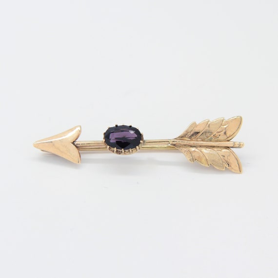 Antique 9k gold arrow brooch with purple sapphire