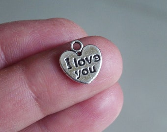 May include: Silver heart-shaped charm with the words "I love you" engraved on it.