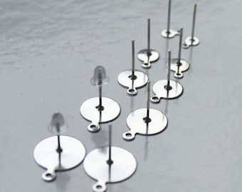 May include: A set of ten silver earring posts with round backs. The posts are made of metal and have a smooth finish. The backs are also made of metal and have a slightly textured finish.