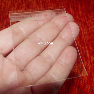May include: Clear plastic resealable bag with a red label that says "LIJIA" and "RESEAL". The bag is 7 cm by 5 cm.