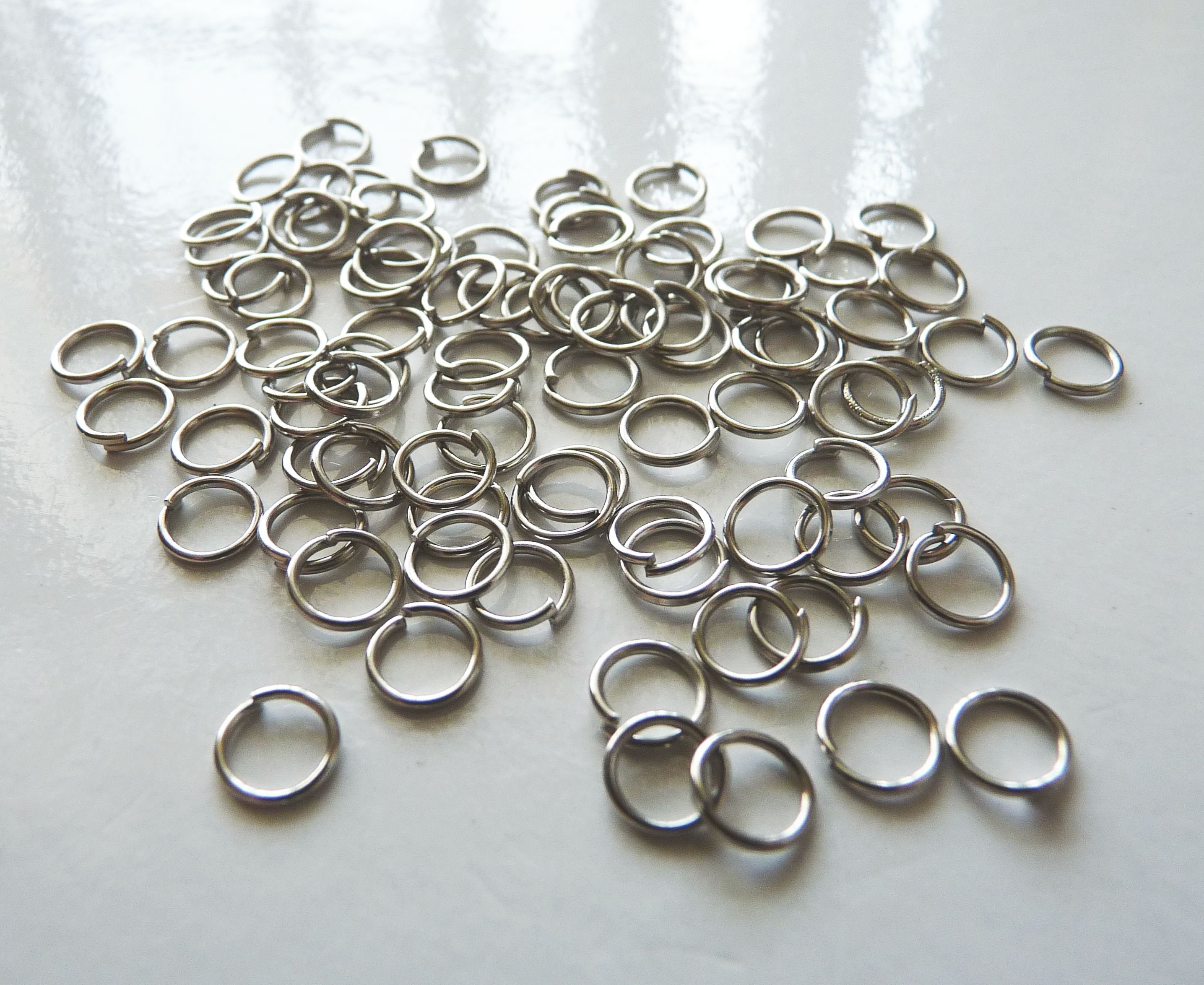 100 anelli di salto 8mm tono argento FS496 