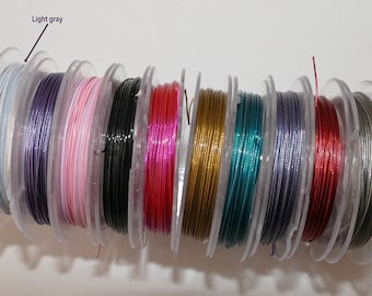 May include: Spools of colorful wire in various metallic shades, including light gray, purple, pink, black, red, gold, teal, silver, and copper.