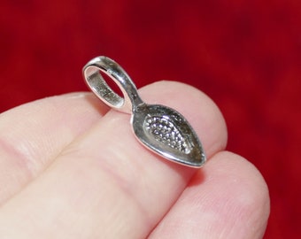 May include: Silver-toned metal pendant bail with a teardrop shape and a textured surface.