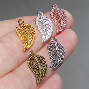 May include: Five silver, gold, and copper leaf charms with intricate filigree designs. The charms are ideal for jewellery making, scrapbooking, and other craft projects.