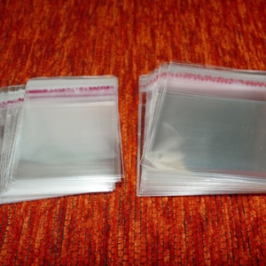 May include: A stack of clear plastic bags with a red and white label that says "MOVE JAPAN TO ENCORE".