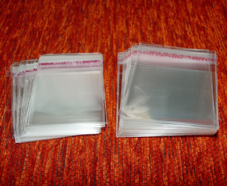 May include: A stack of clear plastic bags with a red and white label that says "MOVE JAPAN TO ENCORE".