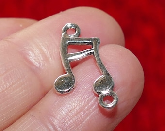 May include: Silver charm in the shape of a musical note. The charm has a loop at the top for attaching to a necklace or bracelet.