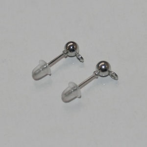 May include: Two silver earring posts with clear rubber backs. The posts have a small silver ball at the top and a loop at the bottom.