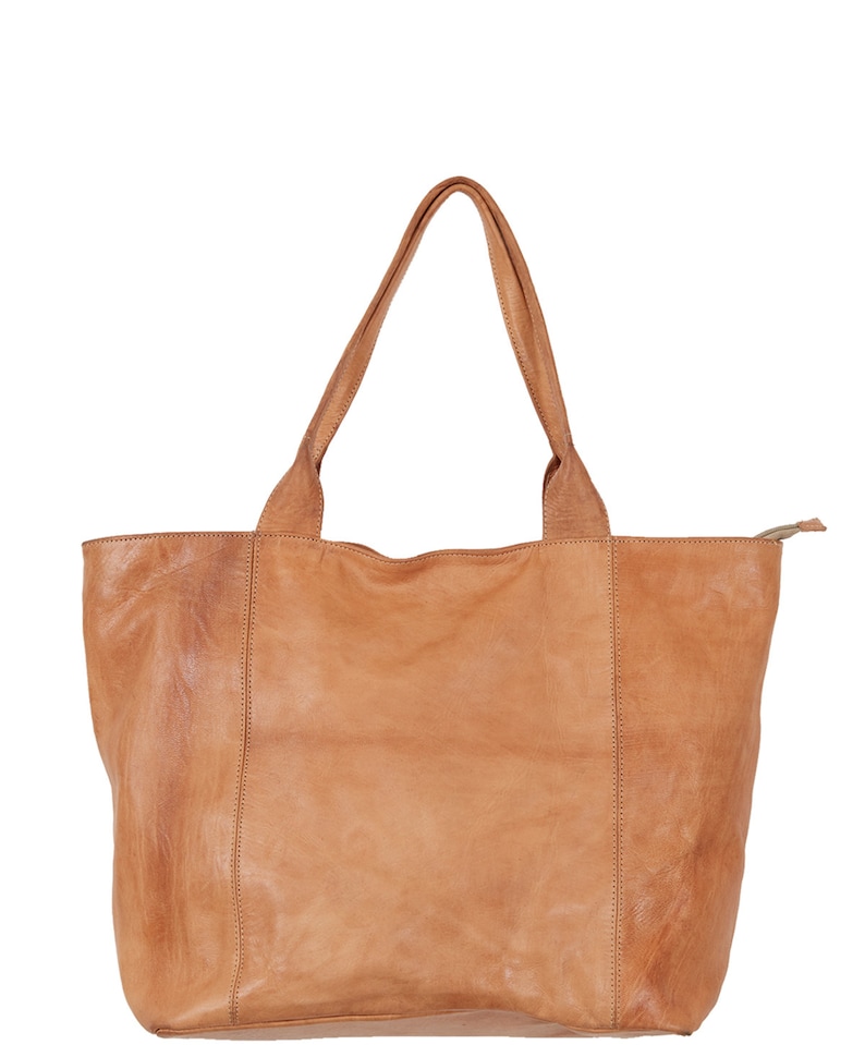 May include: A tan leather tote bag with two handles. The bag has a zipper closure and a slightly distressed look.