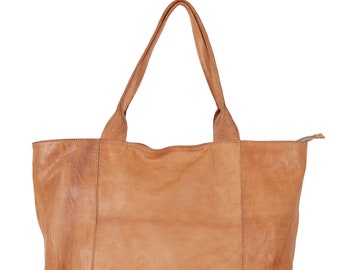 May include: A large, brown leather tote bag with two handles. The bag has a zipper closure and a slightly distressed look.